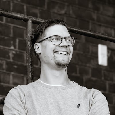 A black and white image of smiling Marko Klemetti, the CTO of Eficode, looking to the horizon.